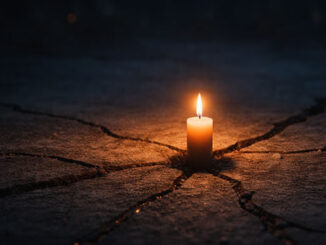 eine Kerze auf kaputtem Asphalt