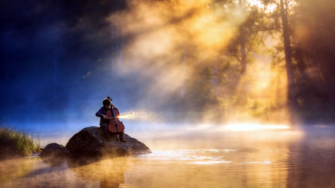musizierender junger Mann bei Sonnenaufgang